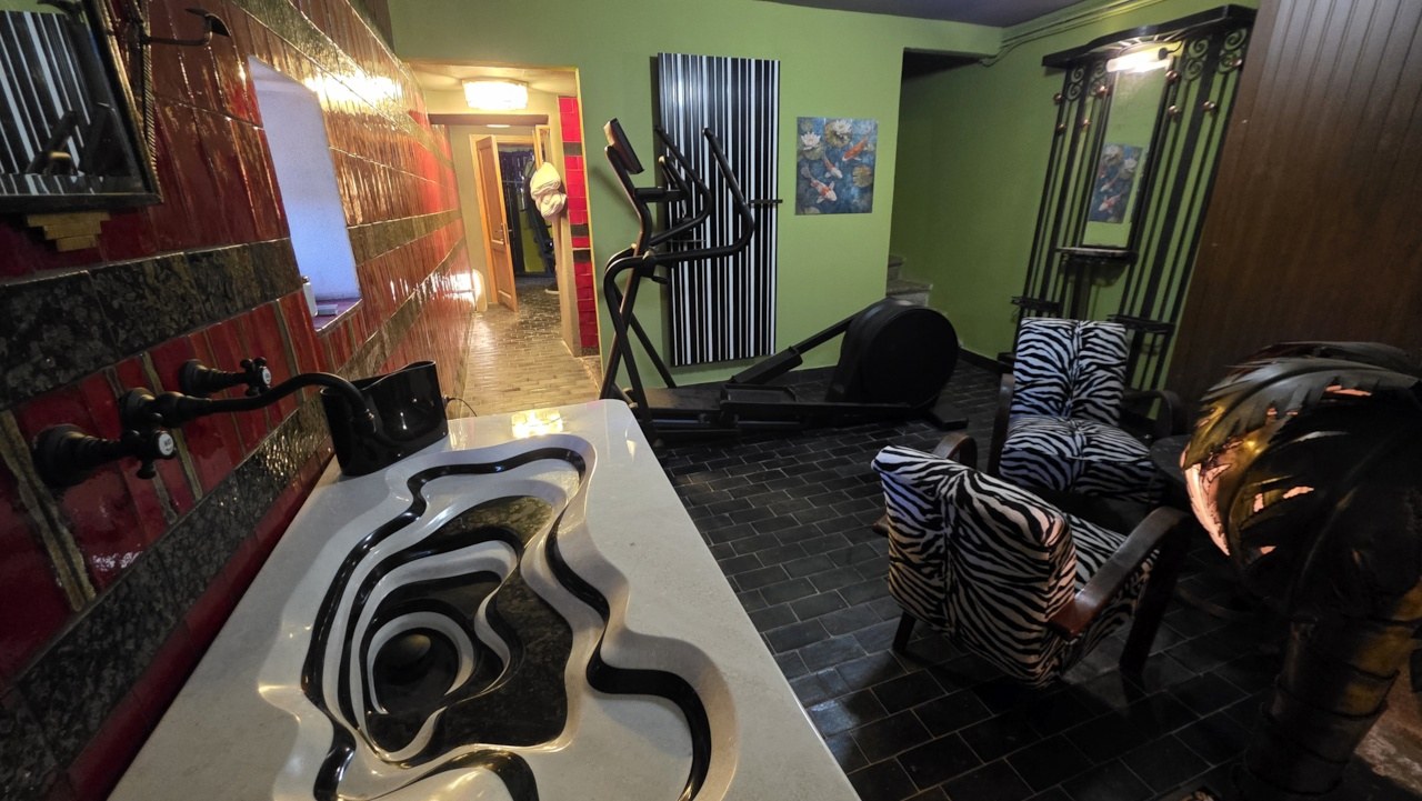 The indoor Vallico Academy training room with Technogym equipment and sculptural washbasin