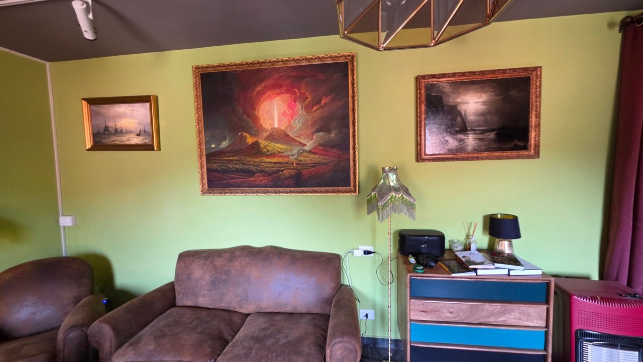 Original oil paintings above the armchairs in the Vallico Academy living room